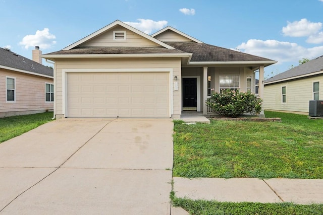 view of front facade with central AC, a garage, and a front yard