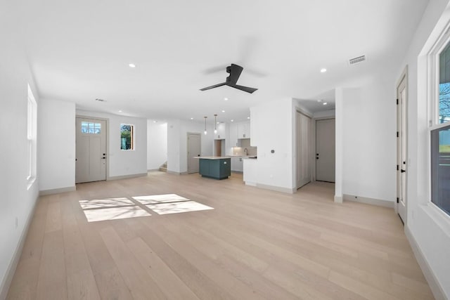 512 W Saint Johns Ave Unit A, Austin, TX 78752 - unfurnished living room featuring ceiling fan, light wood finished floors, recessed lighting, and baseboards