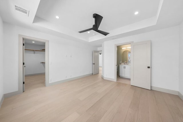 512 W Saint Johns Ave Unit A, Austin, TX 78752 - unfurnished bedroom with a raised ceiling, light wood-type flooring, baseboards, recessed lighting, and ceiling fan