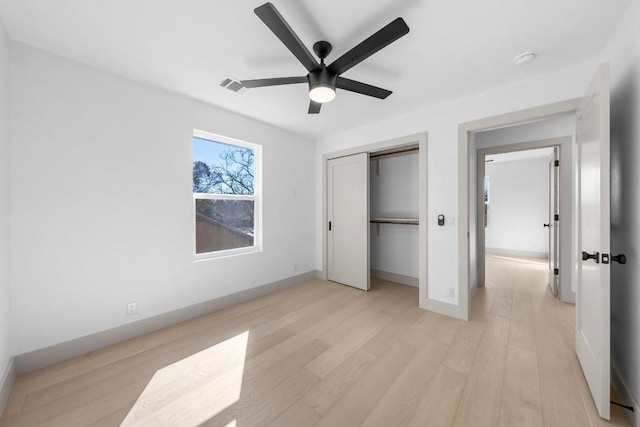 512 W Saint Johns Ave Unit A, Austin, TX 78752 - unfurnished bedroom featuring light wood-style floors, a closet, baseboards, and a ceiling fan