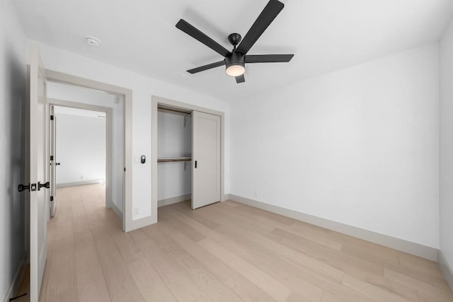 512 W Saint Johns Ave Unit A, Austin, TX 78752 - unfurnished bedroom with light wood-style flooring, baseboards, a closet, and a ceiling fan