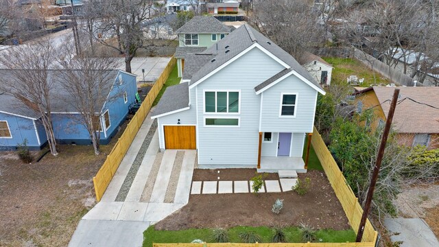 512 W Saint Johns Ave Unit A, Austin, TX 78752 - rear view of house featuring roof with shingles, driveway, a residential view, and a porch