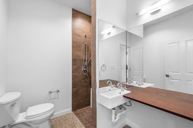 full bath with tile patterned floors, baseboards, toilet, and a walk in shower