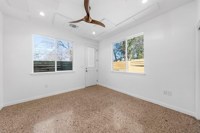 empty room with visible vents, baseboards, recessed lighting, speckled floor, and a ceiling fan