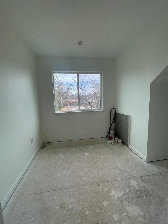 unfurnished room featuring baseboards