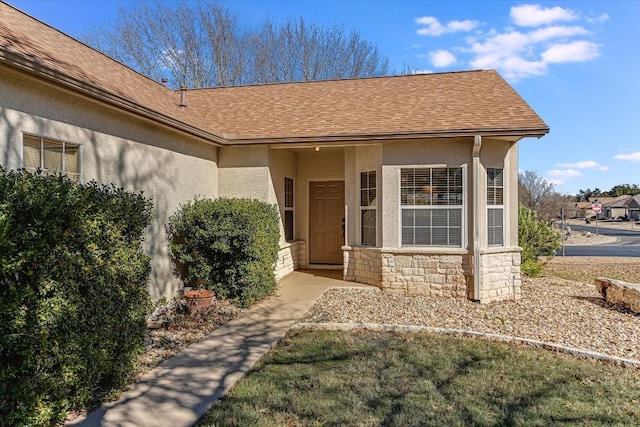 doorway to property featuring a yard