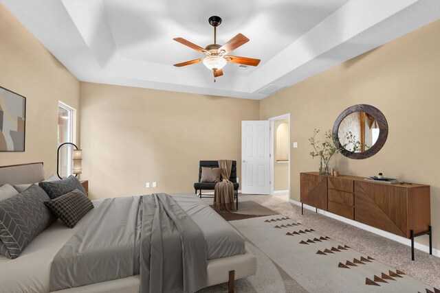205 Errol Dr, Spicewood, TX 78669 - carpeted bedroom featuring a tray ceiling, baseboards, and ceiling fan