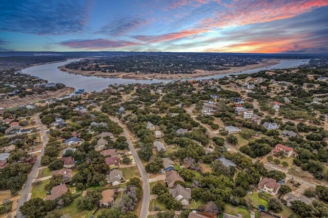 aerial view at dusk with a water view