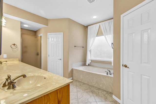 205 Errol Dr, Spicewood, TX 78669 - full bath featuring marble finish flooring, a garden tub, double vanity, a stall shower, and recessed lighting