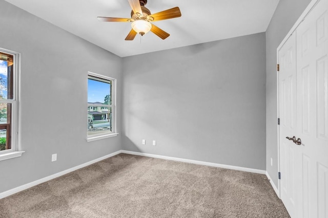 unfurnished bedroom with a closet, ceiling fan, and carpet flooring