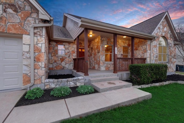 exterior entry at dusk featuring covered porch