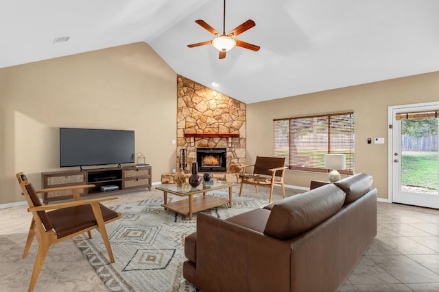 living room featuring a stone fireplace, high vaulted ceiling, and ceiling fan