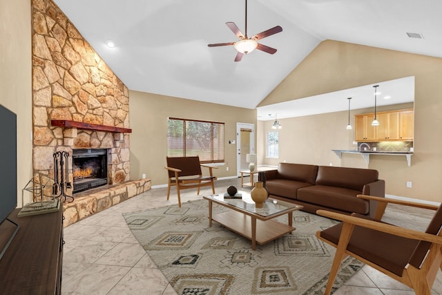 living room featuring a fireplace, high vaulted ceiling, and ceiling fan