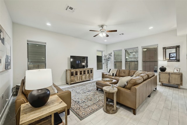 living room with light wood-type flooring and ceiling fan