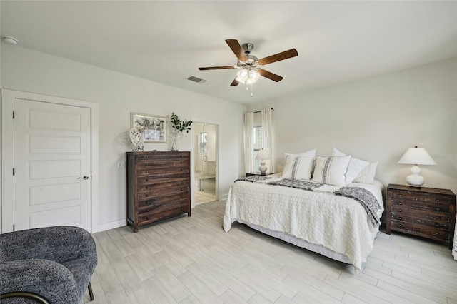 bedroom with ensuite bath, ceiling fan, and light hardwood / wood-style flooring