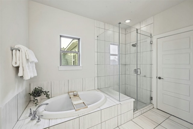 bathroom with separate shower and tub