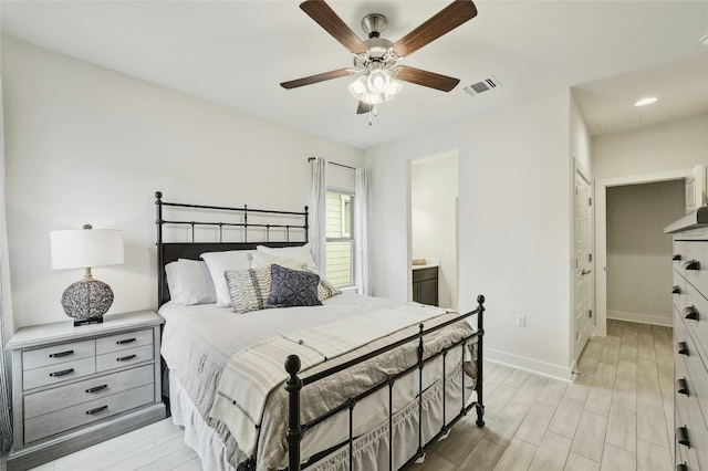 bedroom featuring ceiling fan, connected bathroom, and light hardwood / wood-style floors