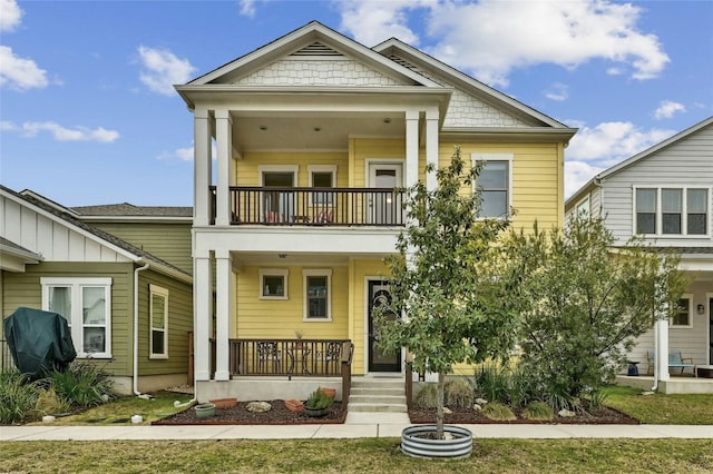 view of front of property with a balcony and covered porch