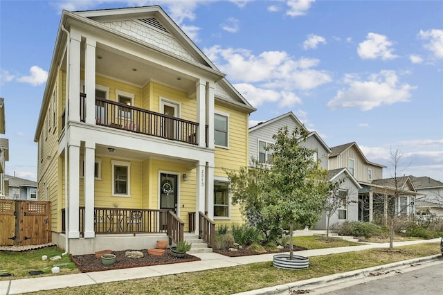 view of front of house featuring a balcony and a porch