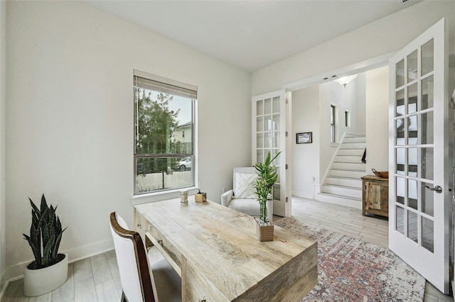 dining area with french doors and hardwood / wood-style floors