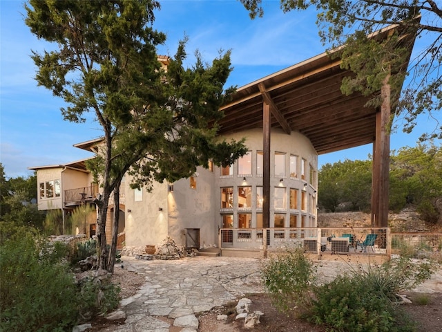 back of house with a balcony and central air condition unit