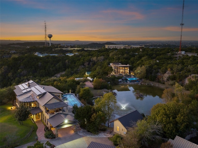 aerial view at dusk with a water view