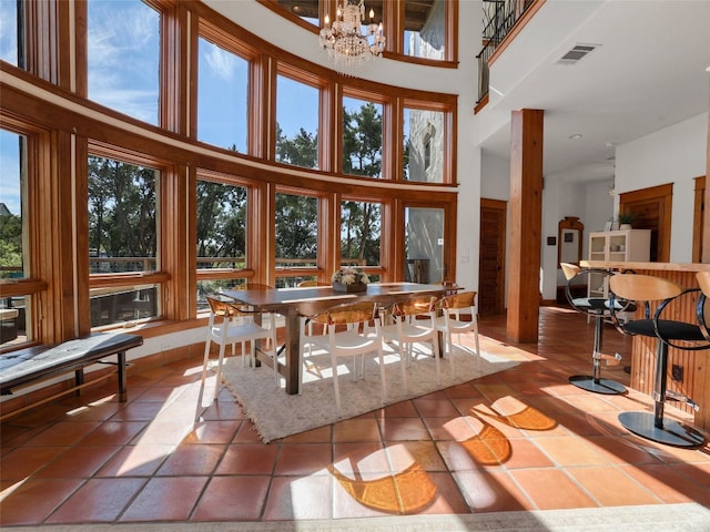 608 Crystal Creek Dr, Austin, TX 78746 - tiled dining space with a high ceiling and a chandelier