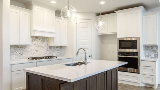 220 La Venta Loop, Liberty Hill, TX 78642 - kitchen featuring appliances with stainless steel finishes, recessed lighting, white cabinets, and tasteful backsplash