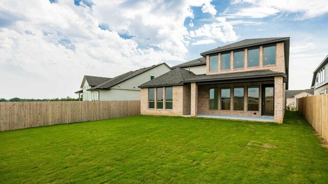220 La Venta Loop, Liberty Hill, TX 78642 - rear view of house featuring a fenced backyard, a patio area, brick siding, and roof with shingles
