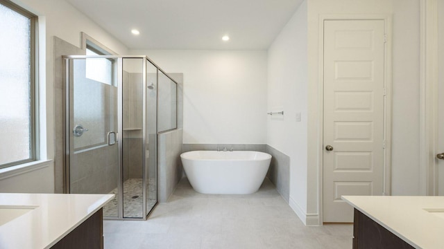 220 La Venta Loop, Liberty Hill, TX 78642 - full bath featuring vanity, a stall shower, a freestanding tub, and recessed lighting