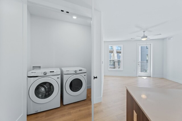 1701 Simond Ave Unit 546, Austin, TX 78723 - laundry room featuring washing machine and clothes dryer, ceiling fan, light wood-type flooring, and baseboards