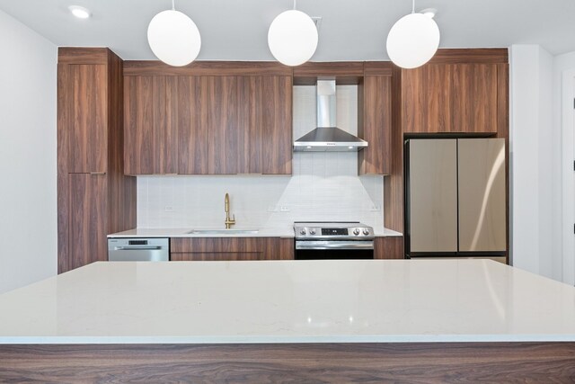 1701 Simond Ave Unit 546, Austin, TX 78723 - kitchen featuring stainless steel appliances, modern cabinets, wall chimney range hood, a sink, and light countertops
