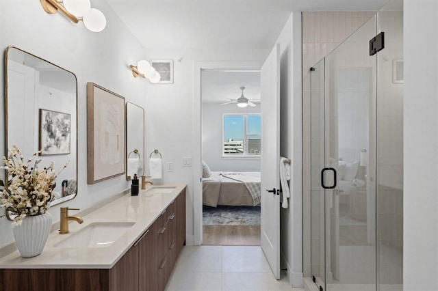 bathroom featuring ceiling fan, tile patterned floors, a shower with door, and vanity