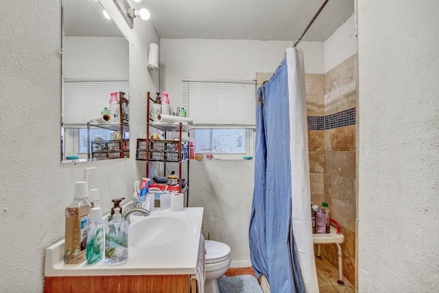 bathroom featuring a shower with curtain, vanity, and toilet