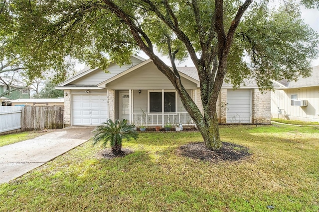 single story home featuring a porch, a garage, and a front lawn