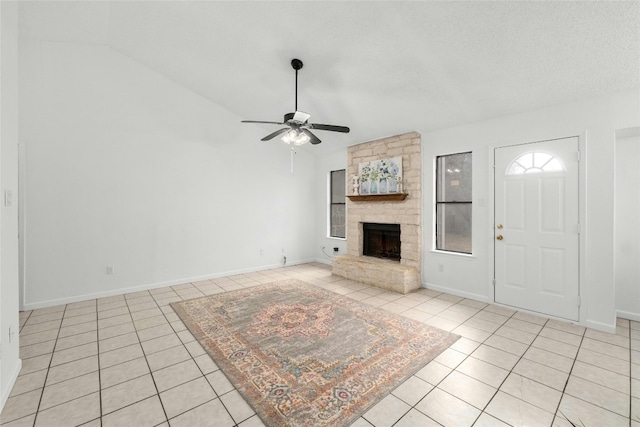 unfurnished living room featuring light tile patterned floors, a fireplace, ceiling fan, and vaulted ceiling