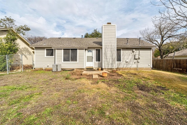 back of house featuring a yard and central air condition unit