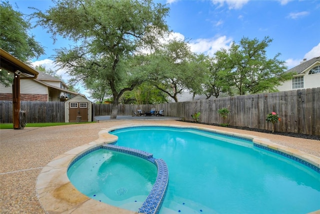 view of pool with a storage shed and a patio area