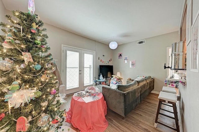 living room with hardwood / wood-style floors and french doors