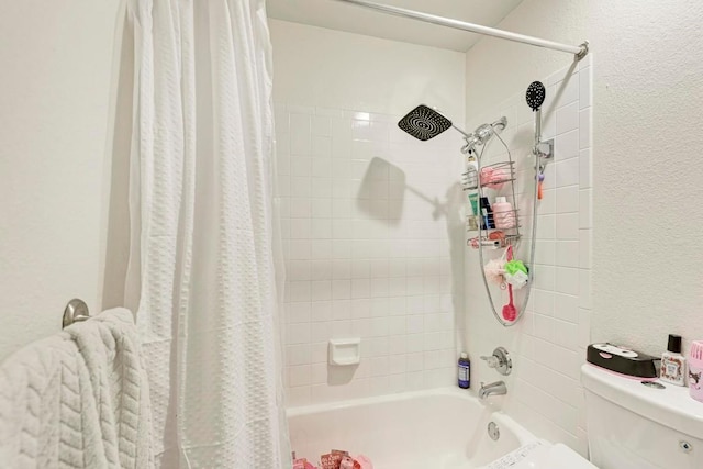 bathroom with shower / bathtub combination with curtain and toilet