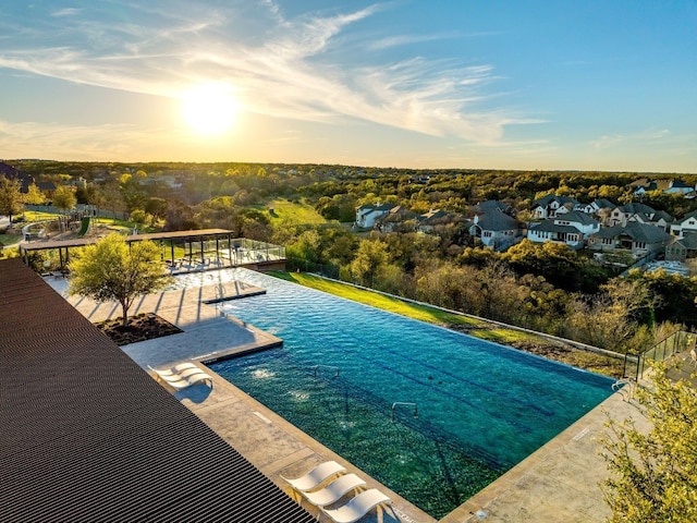 pool at dusk with a patio