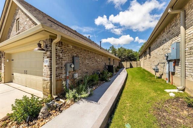 view of property exterior with central AC unit and a lawn