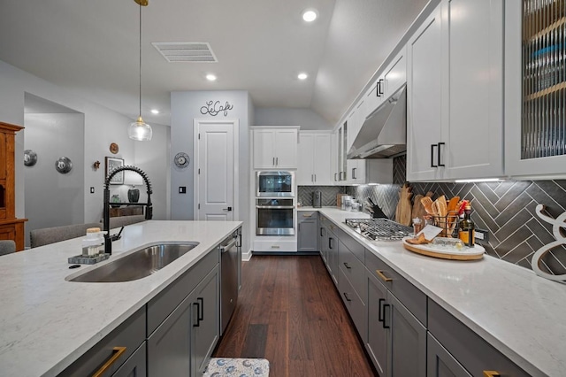 kitchen featuring hanging light fixtures, gray cabinets, stainless steel appliances, and sink