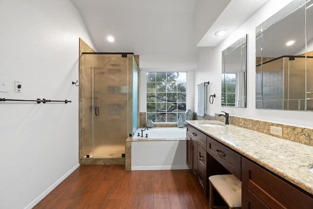 bathroom featuring shower with separate bathtub, lofted ceiling, hardwood / wood-style floors, and vanity