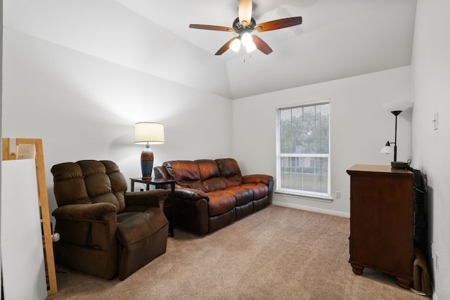 carpeted living room with ceiling fan and vaulted ceiling