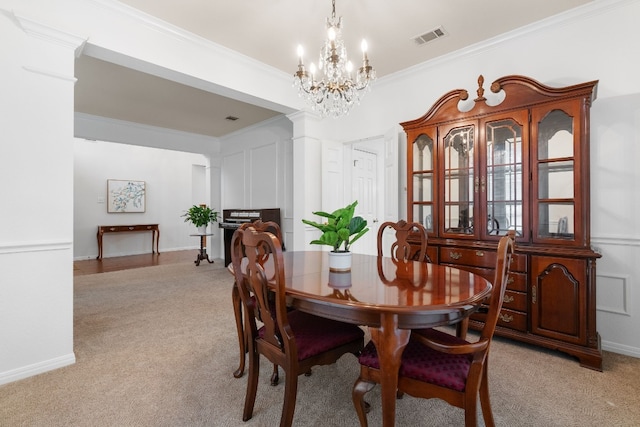 carpeted dining room featuring crown molding and a chandelier