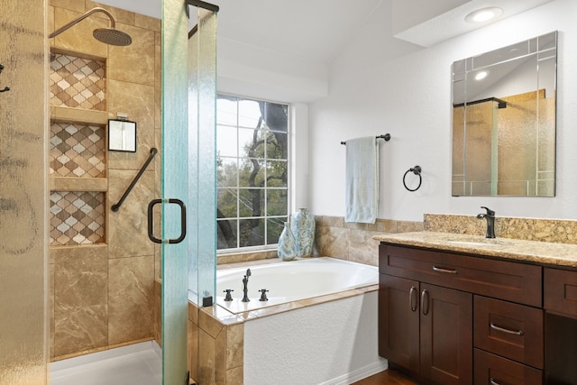 bathroom with plus walk in shower, vaulted ceiling, and vanity