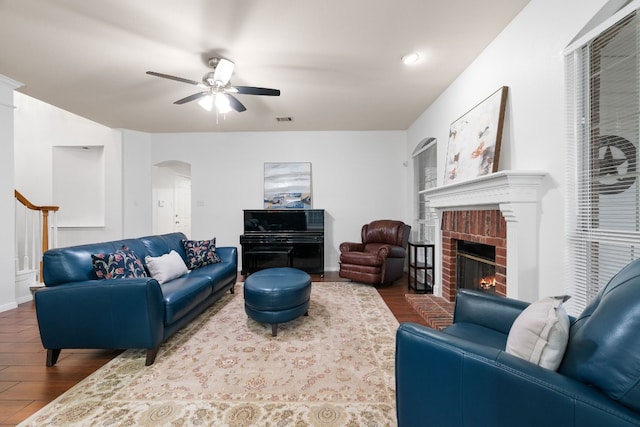 living room with hardwood / wood-style flooring, a fireplace, and ceiling fan