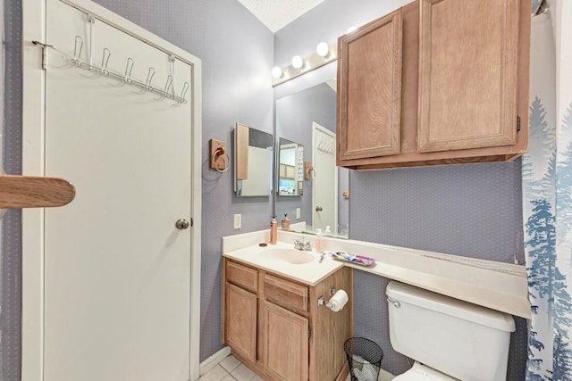 bathroom featuring vanity, tile patterned floors, and toilet