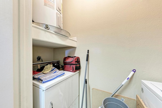 clothes washing area featuring washer and clothes dryer